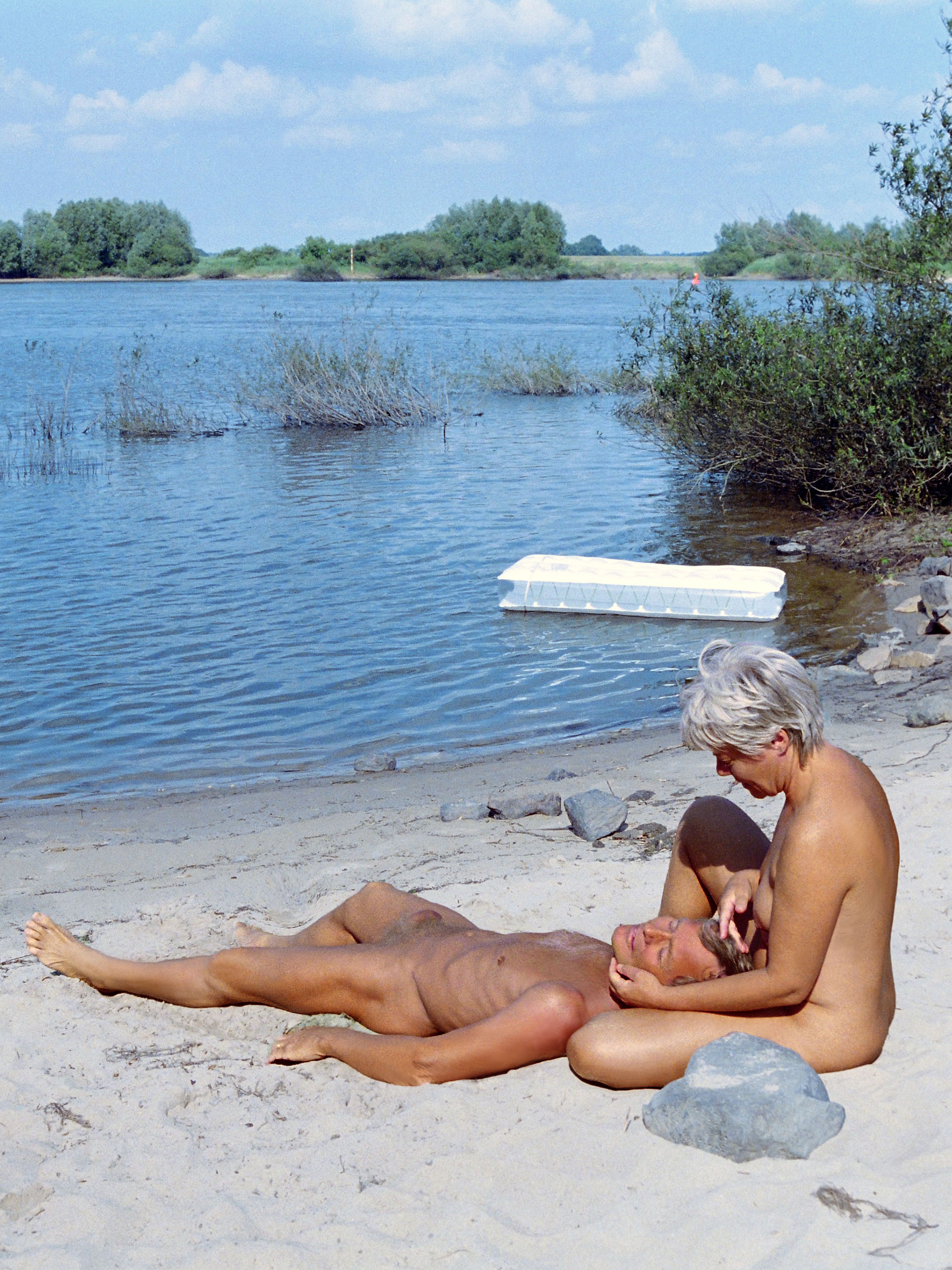 Nudism - naked couple on the banks of the Elbe